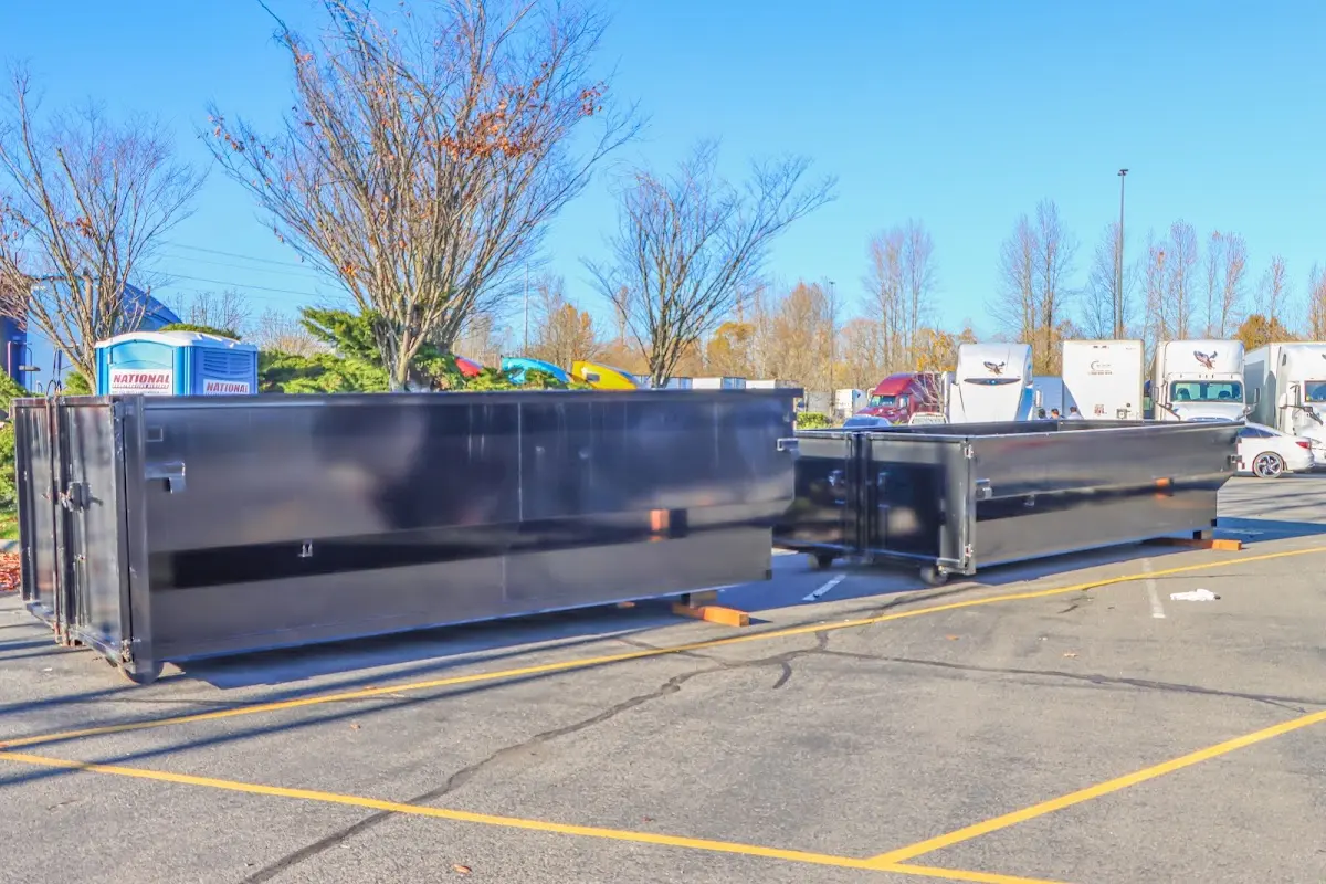 Professional dumpster rental service with roll-off container on residential driveway in Tolland